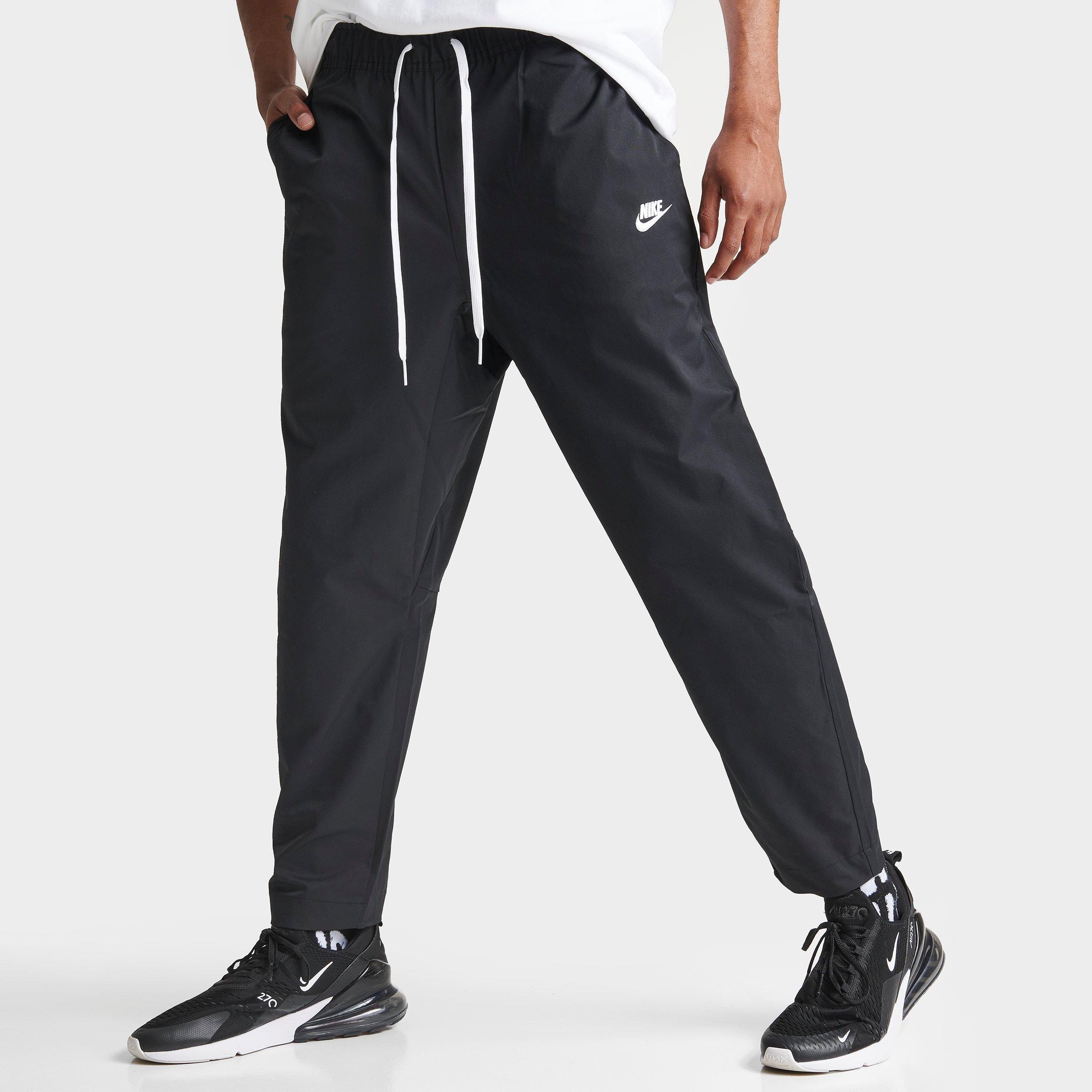 Shop Nike Men's Club Woven Tapered Pants In Black/white