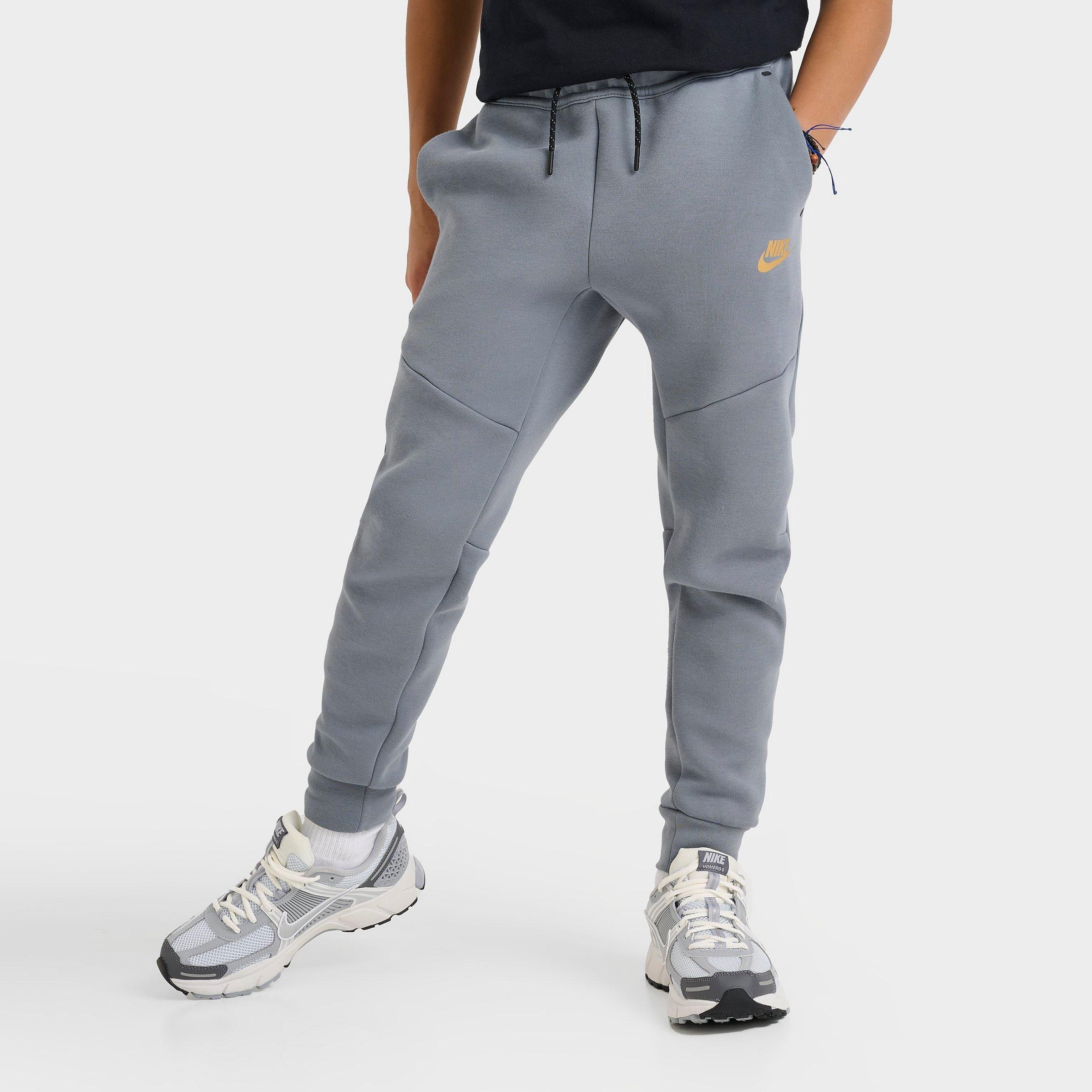 Nike Big Kids Sportswear Tech Fleece Reflective Jogger Pants in Cool Grey/Black/Metallic Gold Size: Small